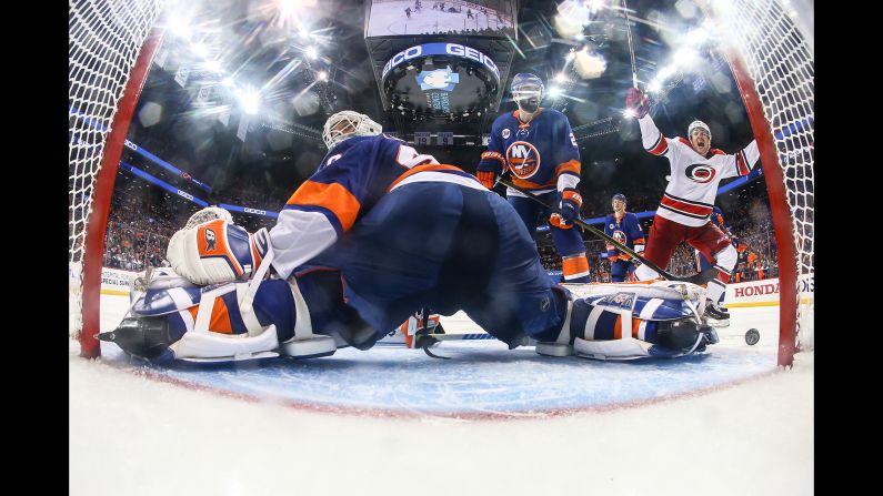 Teuvo Teravainen, far right, of the Carolina Hurricanes celebrates Jordan Staal's game winning overtime goal as Robin Lehner and Nick Leddy of the New York Islanders look on during Game One of the Eastern Conference Second Round during the 2019 NHL Stanley Cup Playoffs at Barclays Center on Friday, April 26.