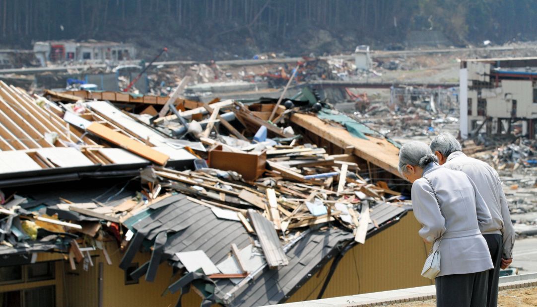 Akihito and Michiko bow in front of collapsed buildings and houses after an earthquake and tsunami devastated Japan in 2011. After the disaster, Akihito made an unprecedented televised address -- the first time any Japanese emperor had spoken to the public on TV. "I truly hope the victims of the disaster never give up hope, take care of themselves and live strong for tomorrow," he said.