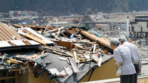 Akihito and Michiko bow in front of collapsed buildings and houses after an earthquake and tsunami devastated Japan in 2011. After the disaster, Akihito made an unprecedented televised address -- the first time any Japanese emperor had spoken to the public on TV. "I truly hope the victims of the disaster never give up hope, take care of themselves and live strong for tomorrow," he said.