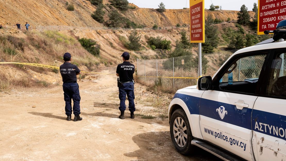 Cypriot forensic police cordon off a suspected dump site at Mitsero Red Lake on April 26, 2019.