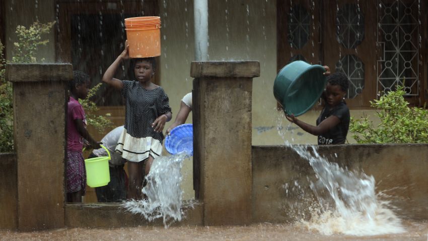 A family desperately scoop water from their flooded home, in Natite neighbourhood, in Pemba, on the northeastern coast of Mozambique, Sunday, April, 28, 2019. Serious flooding began on Sunday in parts of northern Mozambique that were hit by Cyclone Kenneth three days ago, with waters waist-high in areas, after the government urged many people to immediately seek higher ground. Hundreds of thousands of people were at risk. (AP Photo/Tsvangirayi Mukwazhi)