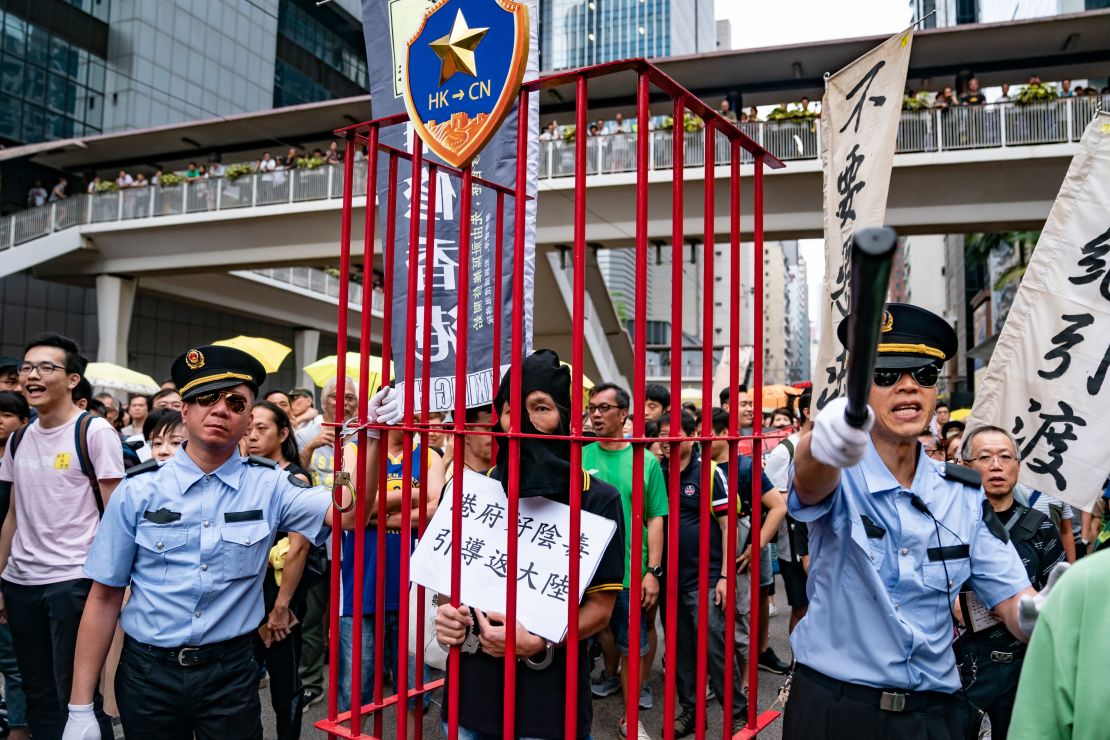 Protesters take part in a march against the proposed extradition law as they hold placards and march on the street on April 28, 2019 in Hong Kong, China. 