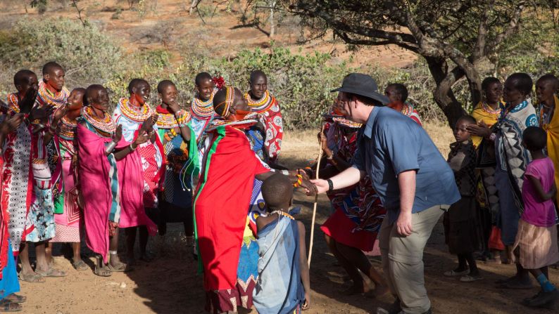 <strong>Dance-off: </strong>Mark McIntire joins in a dancing competition with the villagers. 