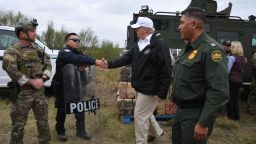 US President Donald Trump(C) greets a policeman with Border Patrol agents,and military after his visit to US Border Patrol McAllen Station in McAllen, Texas, on January 10, 2019. - Trump traveled to the US-Mexico border as part of his all-out offensive to build a wall, a day after he stormed out of negotiations when Democratic opponents refused to agree to fund the project in exchange for an end to a painful government shutdown. (Photo by Jim WATSON / AFP)        (Photo credit should read JIM WATSON/AFP/Getty Images)