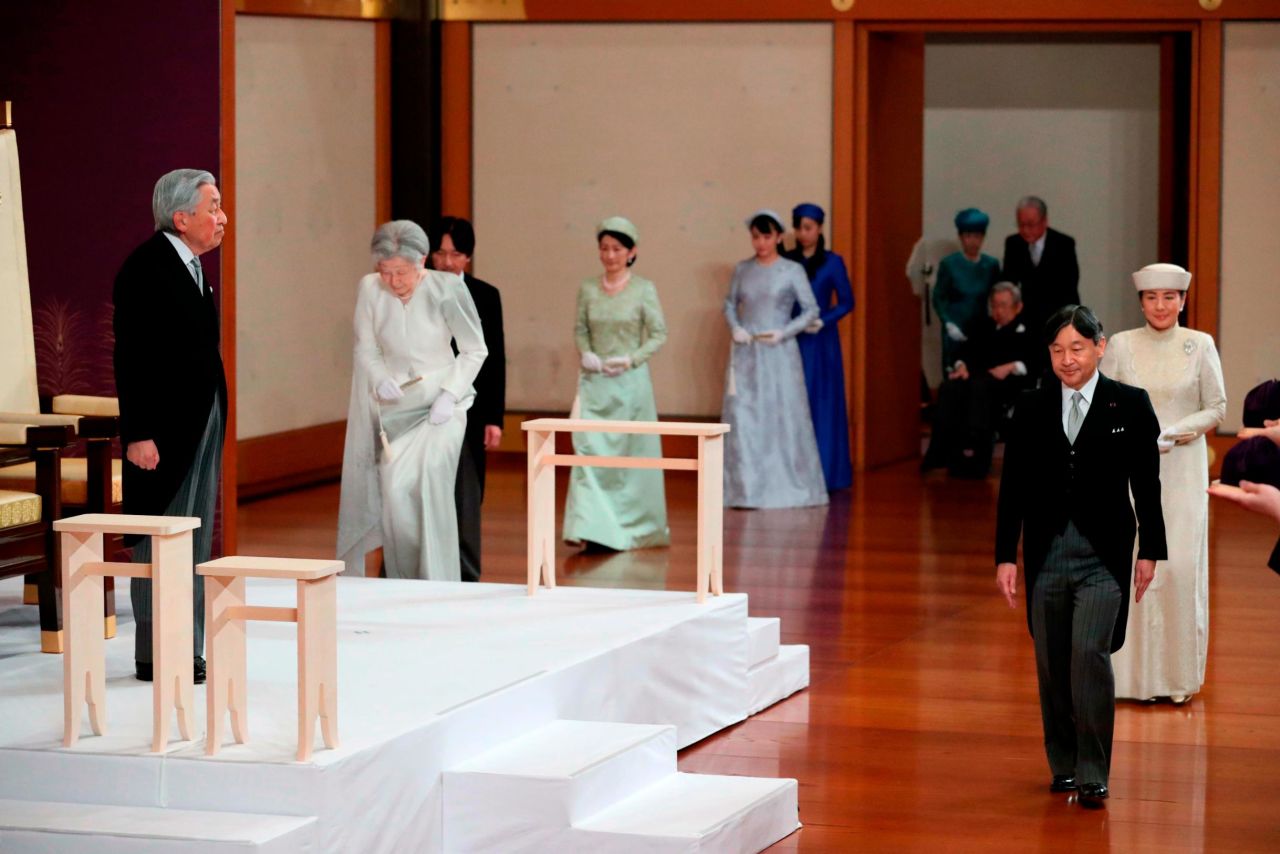 Crown Prince Naruhito walks in front of his father as he arrives for the abdication ceremony.