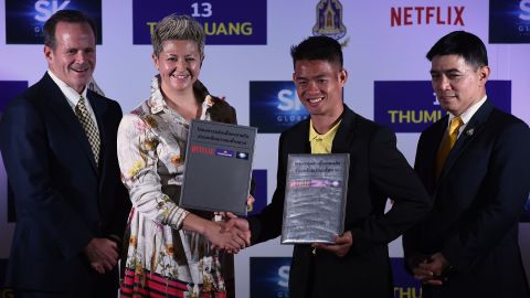 Erika North, Netflix's director of international originals, shook hands with Ekkapol Chantawong, the coach of the 'Wild Boars' soccer club at the press conference.  