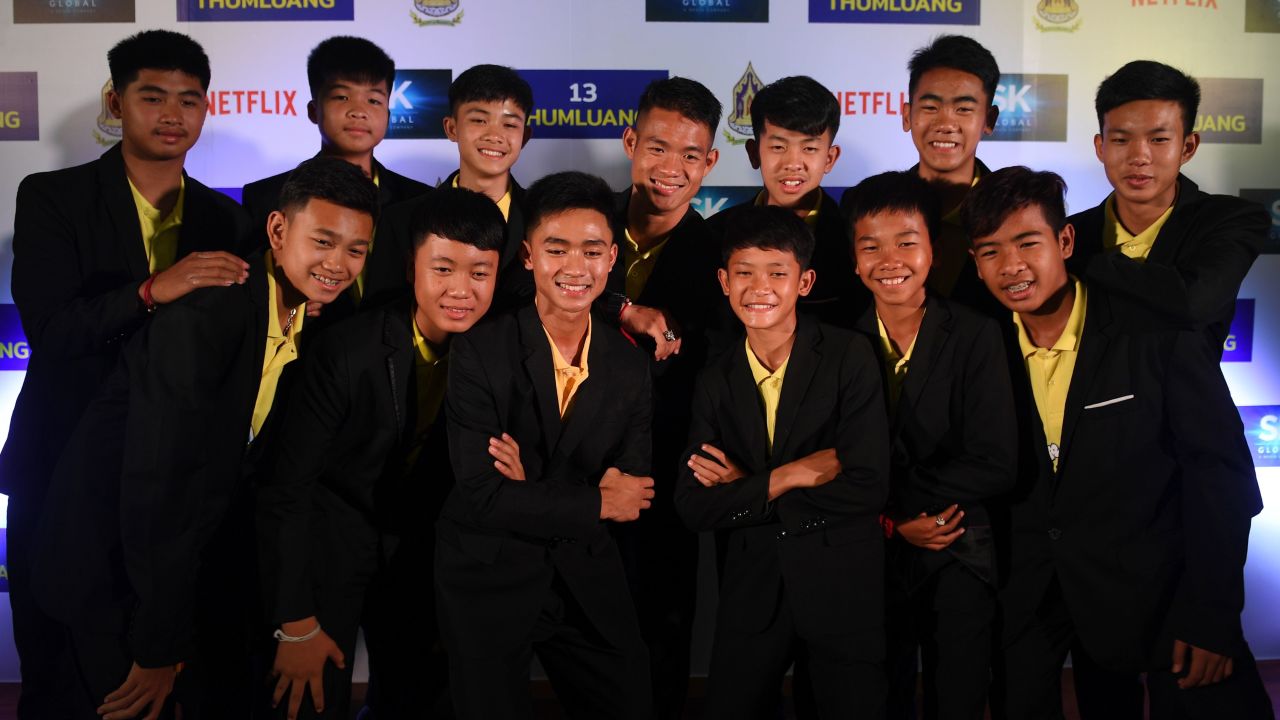 Members of the 'Wild Boars' soccer team posed for a photo alongside their coach during a press conference in Bangkok to announce their deal with Netflix. 