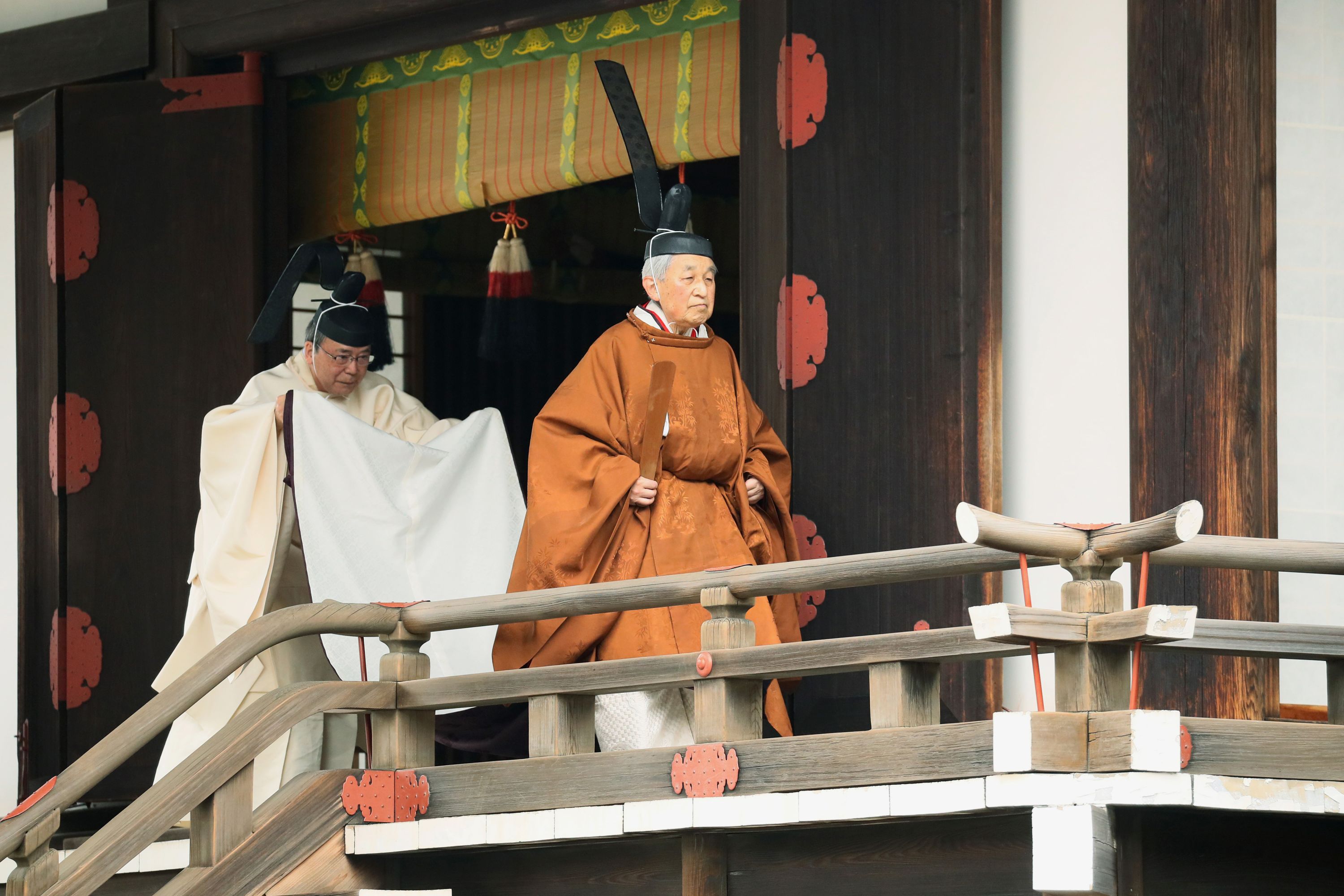 Emperor Akihito, right, departs from a ritual where he reported his abdication to the throne on Tuesday, April 30.