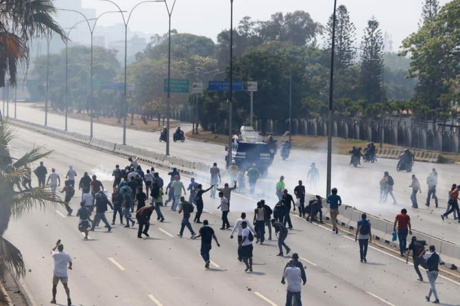 Opposition supporters march near the airbase.