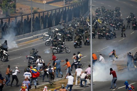 People who oppose Maduro confront troops who were firing tear gas at them outside the La Carlota airbase on April 30.