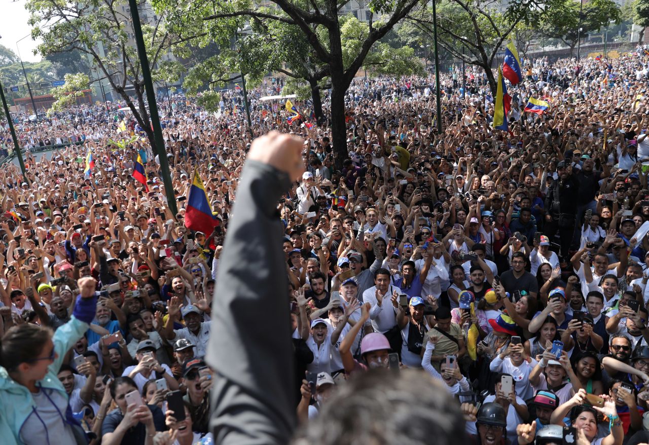 Lopez raises his fist to a crowd of supporters in Caracas on April 30. Lopez is meant to be on house arrest, but he said on Twitter that he was released by the military.