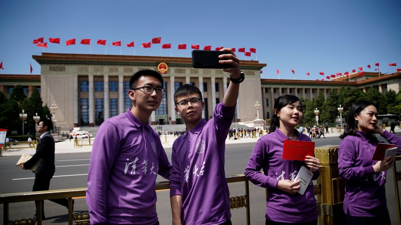 Tsinghua University students take selfies after the conference for the 100th anniversary of May 4th Movement at Great Hall of the People in Beijing.