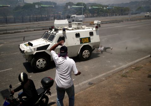 An opposition demonstrator is struck by a Venezuelan National Guard vehicle on a street near the La Carlota airbase on April 30.