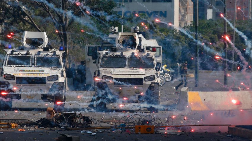 Fireworks launched by opponents of Venezuela's President Nicolas Maduro land near Bolivarian National Guard armored vehicles loyal to Maduro, during an attempted military uprising in Caracas, Venezuela, Tuesday, April 30, 2019. Opposition leader Juan Guaido took to the streets with a small contingent of heavily armed troops in a call for the military to rise up. (AP Photo/Ariana Cubillos)