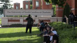 Students and faculty wait near the entrance of campus after a shooting on the campus of University of North Carolina Charlotte in University City, Charlotte, on April 30, 2019. - Six people were shot, two of them died on the University of North Carolina Charlotte campus. One person was taken into custody, according to police sources. (Photo by Logan Cyrus / AFP)        (Photo credit should read LOGAN CYRUS/AFP/Getty Images)