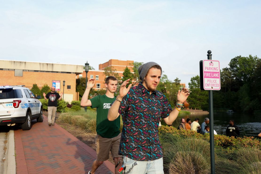 People file out of buildings during a lockdown after the  shooting.