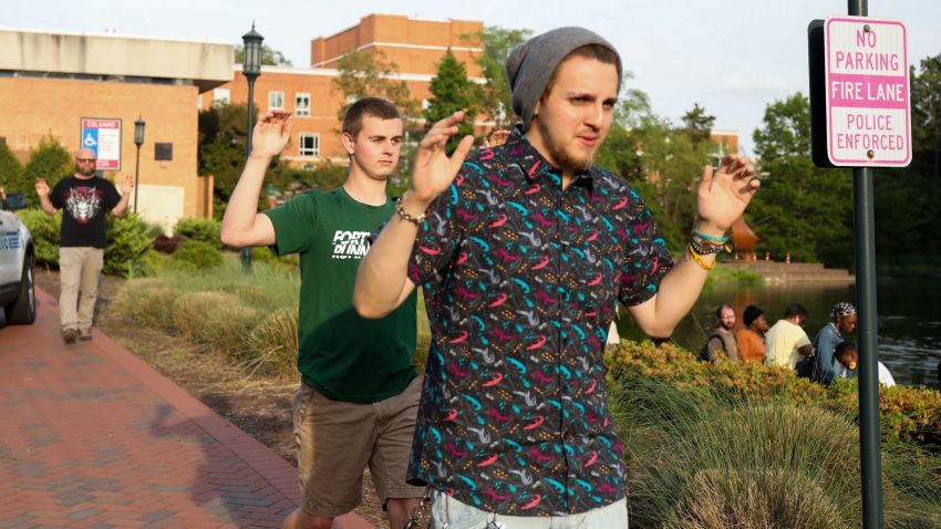 Students and faculty file out of buildings with their hands up during a lockdown after a shooting on the campus of University of North Carolina Charlotte in University City, Charlotte, on April 30, 2019. - Six people were shot, two of them died on the University of North Carolina Charlotte campus. One person was taken into custody, according to police sources. (Photo by Logan Cyrus / AFP) (Photo credit should read LOGAN CYRUS/AFP/Getty Images)
