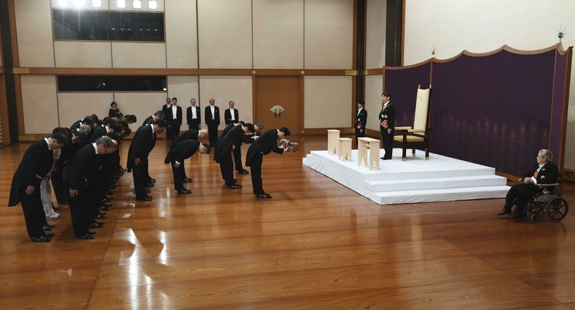 Naruhito, standing on a dais, inherits the imperial regalia during his ascension ceremony in May 2019.