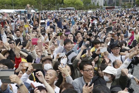 People gather to see the new Emperor and take photos.
