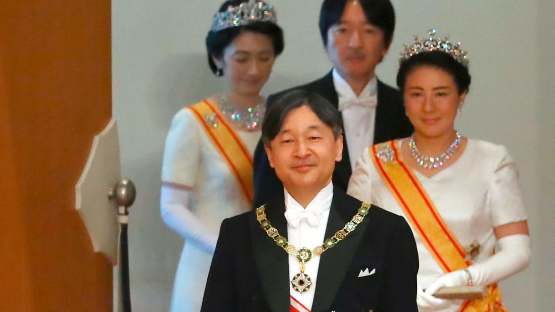 Naruhito is followed by his wife, Masako, as he walks to make his first address as Emperor.