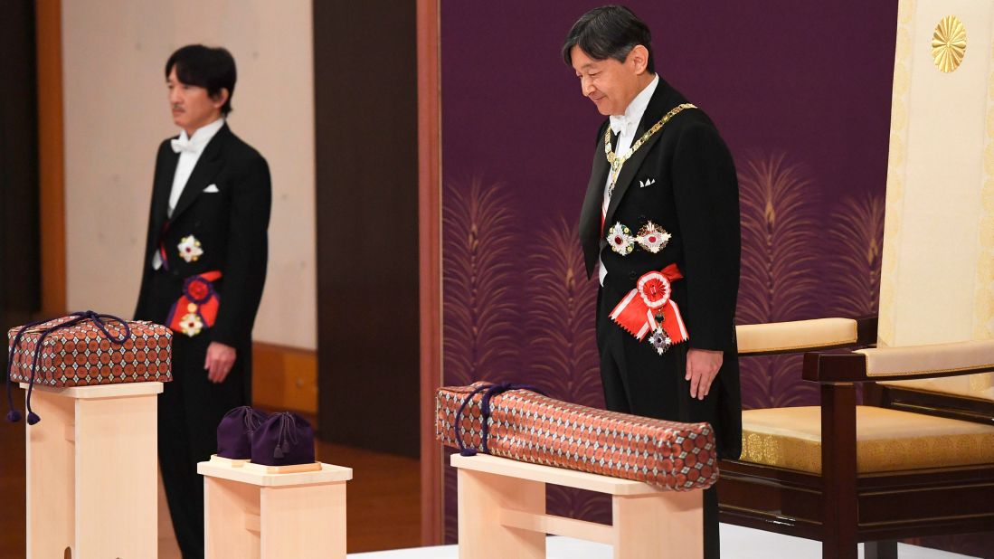 Japan's new Emperor Naruhito, right, attends his coronation ceremony at the Imperial Palace in Tokyo on Wednesday, May 1. Standing at left is his brother, Crown Prince Akishino.