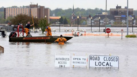 Davenport firefighters used a boat to ferry people from buildings surrounded by floodwater on Tuesday.