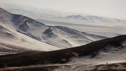 A Mongolian herder on horseback searches for his livestock along the frozen landscape in Bayantsogt, Tuv province in Mongolia.