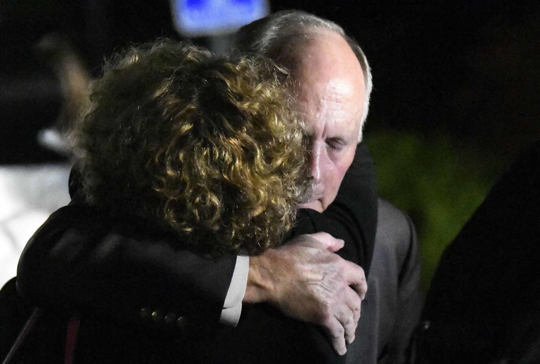 UNC Charlotte Chancellor Philip Dubois receives a hug after a news conference on the deadly shooting.