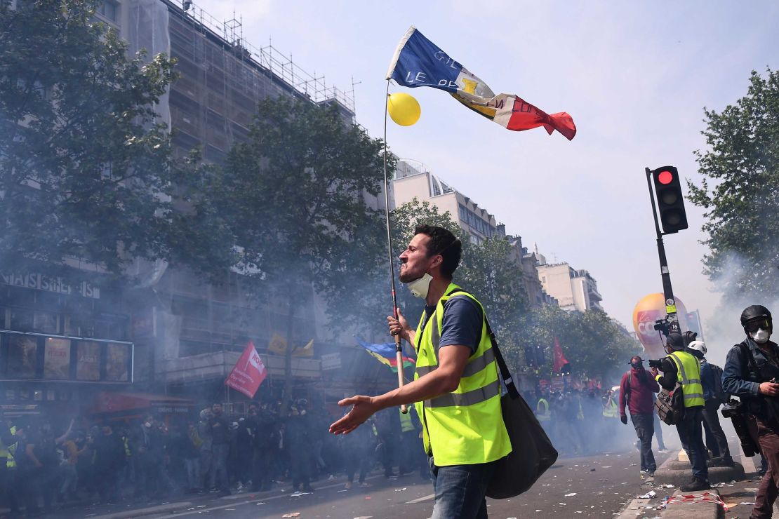 A 'yellow vest' protester holds a French flag during clashes with police on Wednesday. 