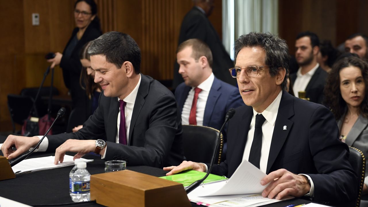 Actor Ben Stiller, front right, and David Miliband, front left, the former British foreign secretary who now leads the International Rescue Committee, sit down to testify before the Senate Foreign Relations Committee on Capitol Hill in Washington, Wednesday, May 1, 2019, during a hearing on the humanitarian Impact of 8 years of war in Syria.