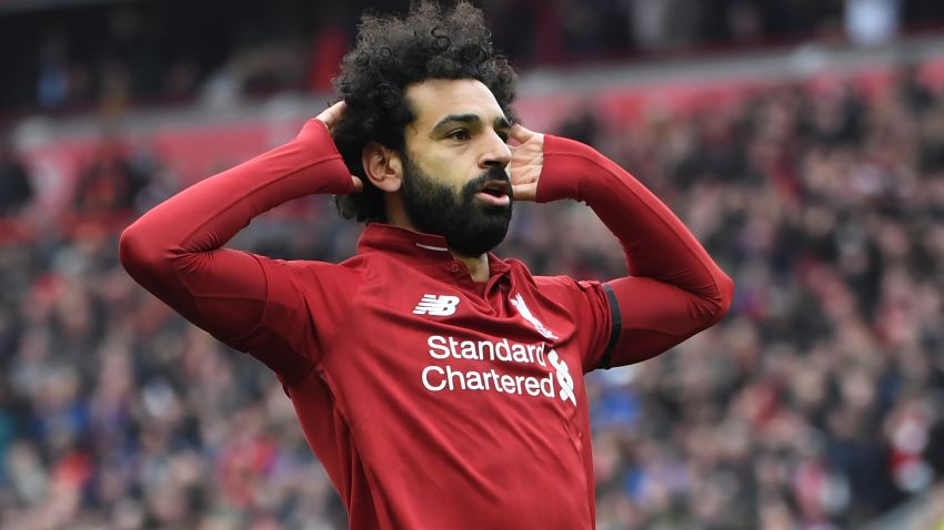 Liverpool's Egyptian midfielder Mohamed Salah celebrates after scoring their second goal during the English Premier League football match between Liverpool and Chelsea at Anfield in Liverpool, north west England on April 14, 2019. (Photo by Paul ELLIS / AFP) / RESTRICTED TO EDITORIAL USE. No use with unauthorized audio, video, data, fixture lists, club/league logos or 'live' services. Online in-match use limited to 120 images. An additional 40 images may be used in extra time. No video emulation. Social media in-match use limited to 120 images. An additional 40 images may be used in extra time. No use in betting publications, games or single club/league/player publications. /         (Photo credit should read PAUL ELLIS/AFP/Getty Images)