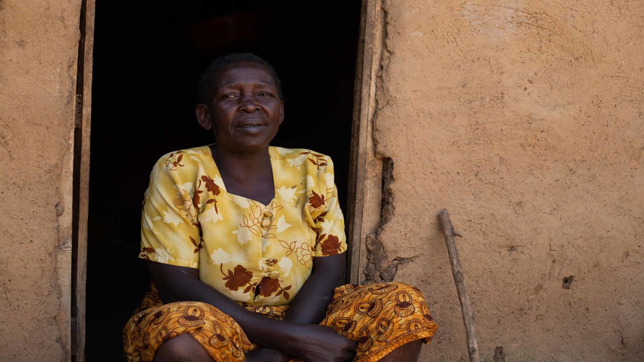 Christina Wambura, 64, sitting in the doorway of her home.