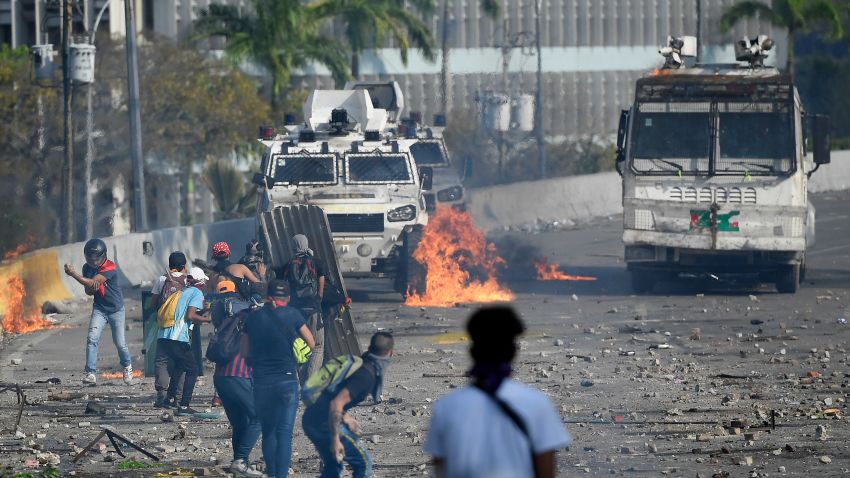 Anti-government protesters clash with security forces in Caracas during the commemoration of May Day on May 1, 2019. - Opposition supporters demonstrated for a second consecutive day in support of their country's self-proclaimed leader Juan Guaido as he bids to overthrow President Nicolas Maduro. Maduro and his government have vowed to put down what they see as an attempted coup by the US-backed opposition leader. (Photo by Federico PARRA / AFP)        (Photo credit should read FEDERICO PARRA/AFP/Getty Images)