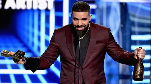 Drake accepts Billboard's top male artist award, one of 12 he carried home Wednesday night.