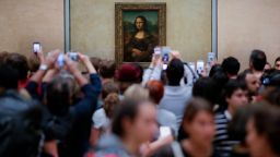 Visitors crowded in front of Leonardo da Vinci's painting 'Mona Lisa' at Musée du Louvre in Paris, Wednesday, June 1, 2016. (AP Photo/Markus Schreiber)