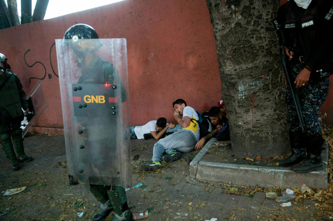 National Police forces detain anti-government protesters near the La Carlota airbase during clashes in Caracas on May 1.
