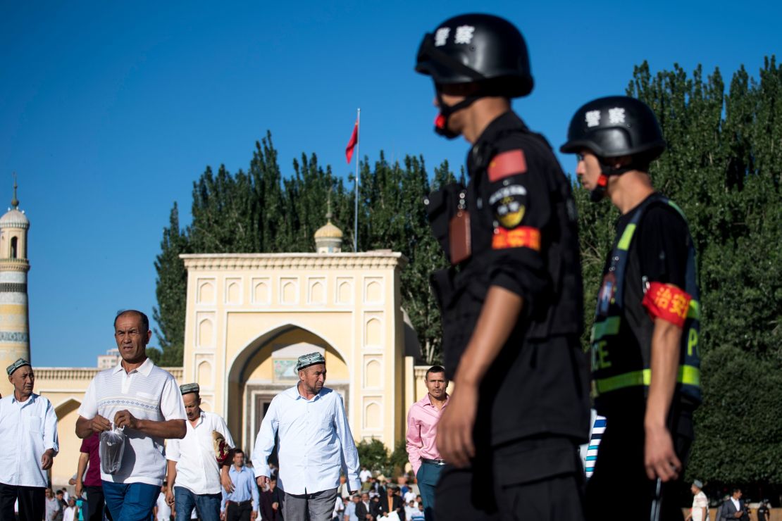 Police patrol as Muslims leave the Id Kah Mosque after morning prayers in the old town of Kashgar in China's Xinjiang Uighur Autonomous Region. 
