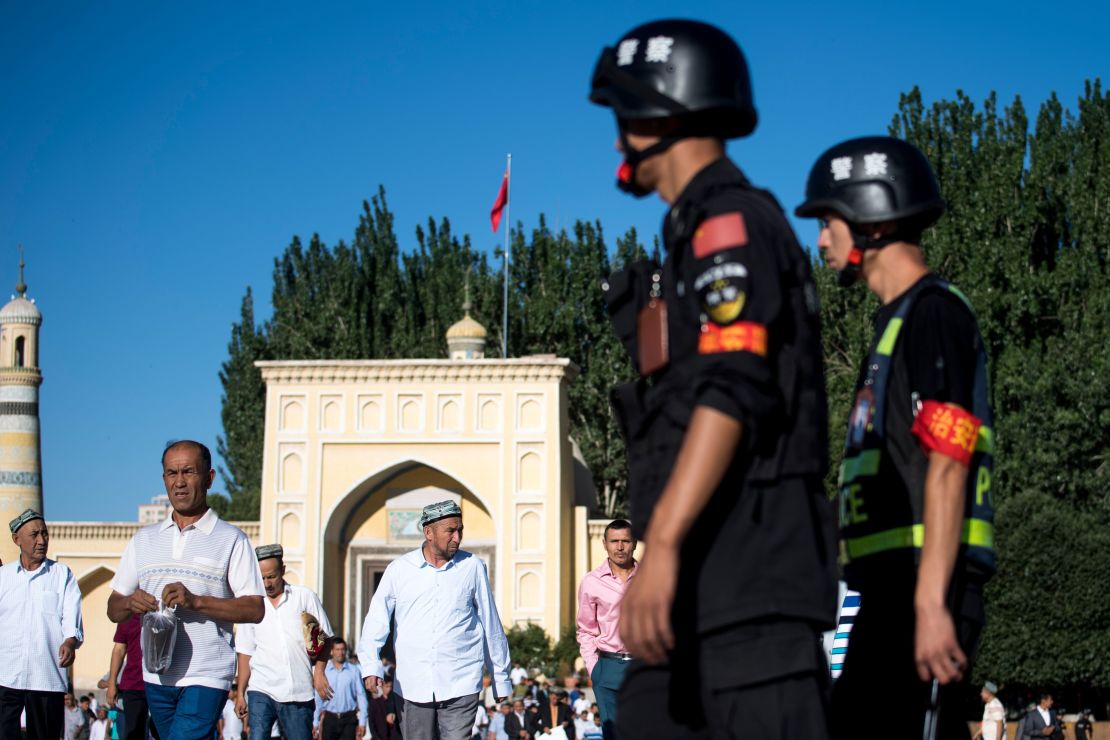 Police patrol as Muslims leave the Id Kah Mosque after morning prayers in the old town of Kashgar in China's Xinjiang Uighur Autonomous Region.