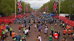 TOPSHOT - Runners recover after running the 2019 London Marathon in central London on April 28, 2019. (Photo by Ben STANSALL / AFP) / Restricted to editorial use - sponsorship of content subject to LMEL agreement.        (Photo credit should read BEN STANSALL/AFP/Getty Images)