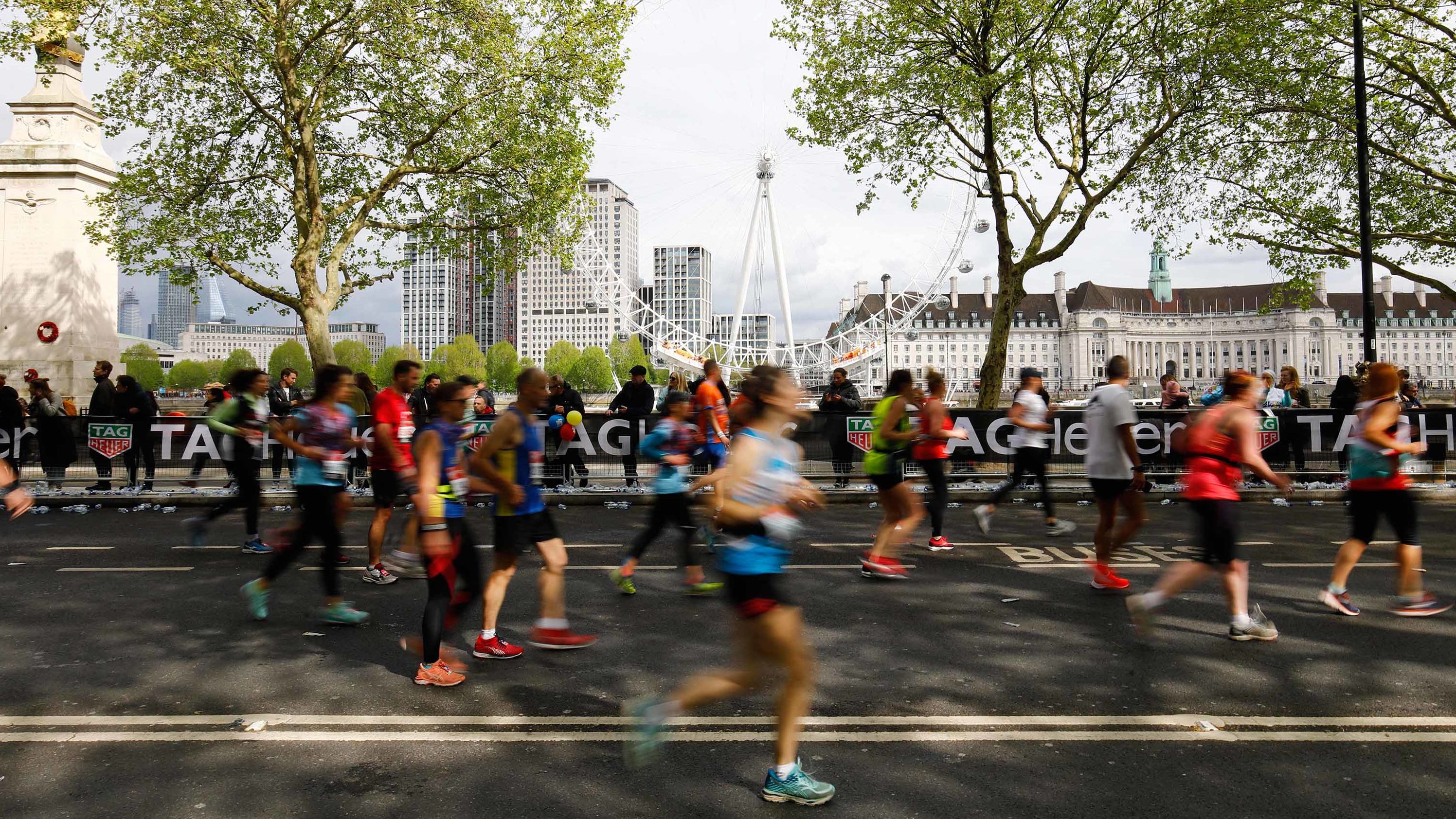 Competitors run along The Embankment with the London Eye seen in the background during the 2019 London Marathon on April 28.