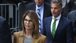 Lori Loughlin, in tan at center, leaves as her husband Mossimo Giannulli, in green tie at right, follows behind her outside the John Joseph Moakley United States Courthouse in Boston on April 3, 2019. Hollywood stars Felicity Huffman and Lori Loughlin were among 13 parents scheduled to appear in federal court in Boston Wednesday for the first time since they were charged last month in a massive college admissions cheating scandal. They were among 50 people - including coaches, powerful financiers, and entrepreneurs - charged in a brazen plot in which wealthy parents allegedly schemed to bribe sports coaches at top colleges to admit their children. Many of the parents allegedly paid to have someone else take the SAT or ACT exams for their children or correct their answers, guaranteeing them high scores. (Photo by Jessica Rinaldi/The Boston Globe via Getty Images)