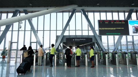 Passengers show their tickets inside the modern terminal.