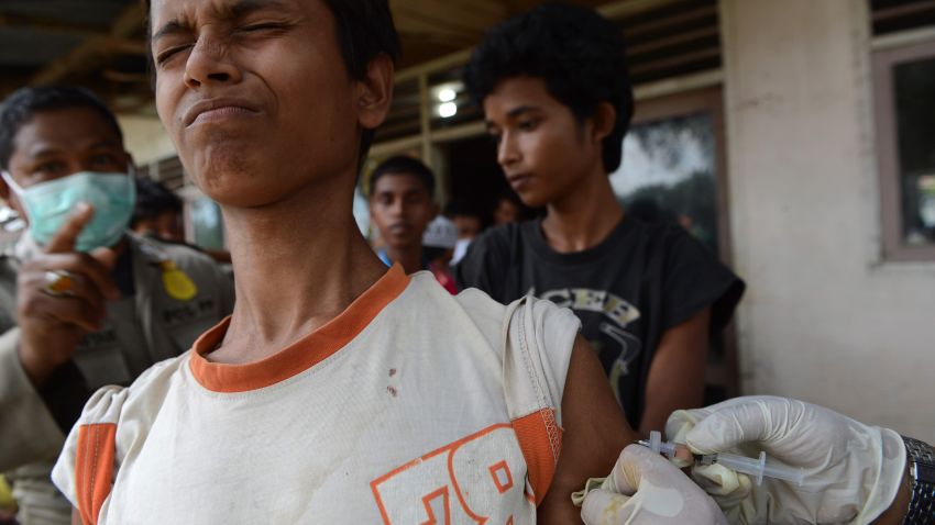 A Rohinyga boy from Myanmar reacts as he receives vaccinations against measles and tetanus from Indonesian health department personnel at the newly set up confinement area in Bayeun, Aceh province on May 22, 2015 after more than 400 Rohingya migrants from Myanmar and Bangladesh were rescued by Indonesian fishermen off the waters of the province on May 20. The widespread persecution of the impoverished community in Rakhine state is one of the primary causes for the current regional exodus, alongside growing numbers trying to escape poverty in neighbouring Bangladesh.  AFP PHOTO / ROMEO GACAD        (Photo credit should read ROMEO GACAD/AFP/Getty Images)