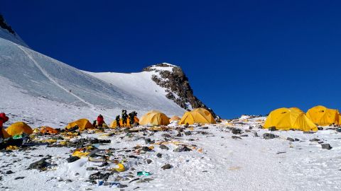 This picture taken on May 21, 2018 shows discarded climbing equipment and rubbish scattered around Camp 4 of Mount Everest. - 