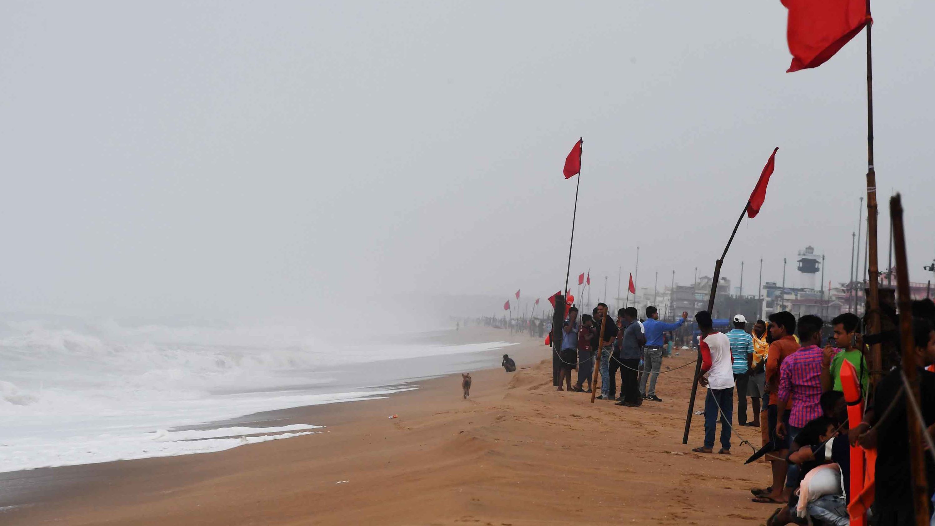 People view the turbulent sea from a closed beach in Puri on Thursday, May 2.