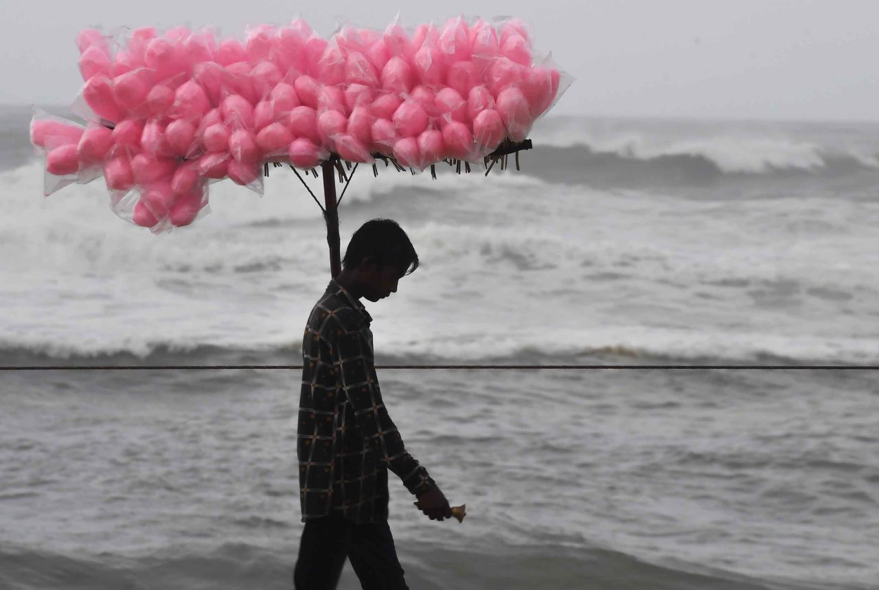 A candy vendor walks along a closed beach in Puri on May 2.