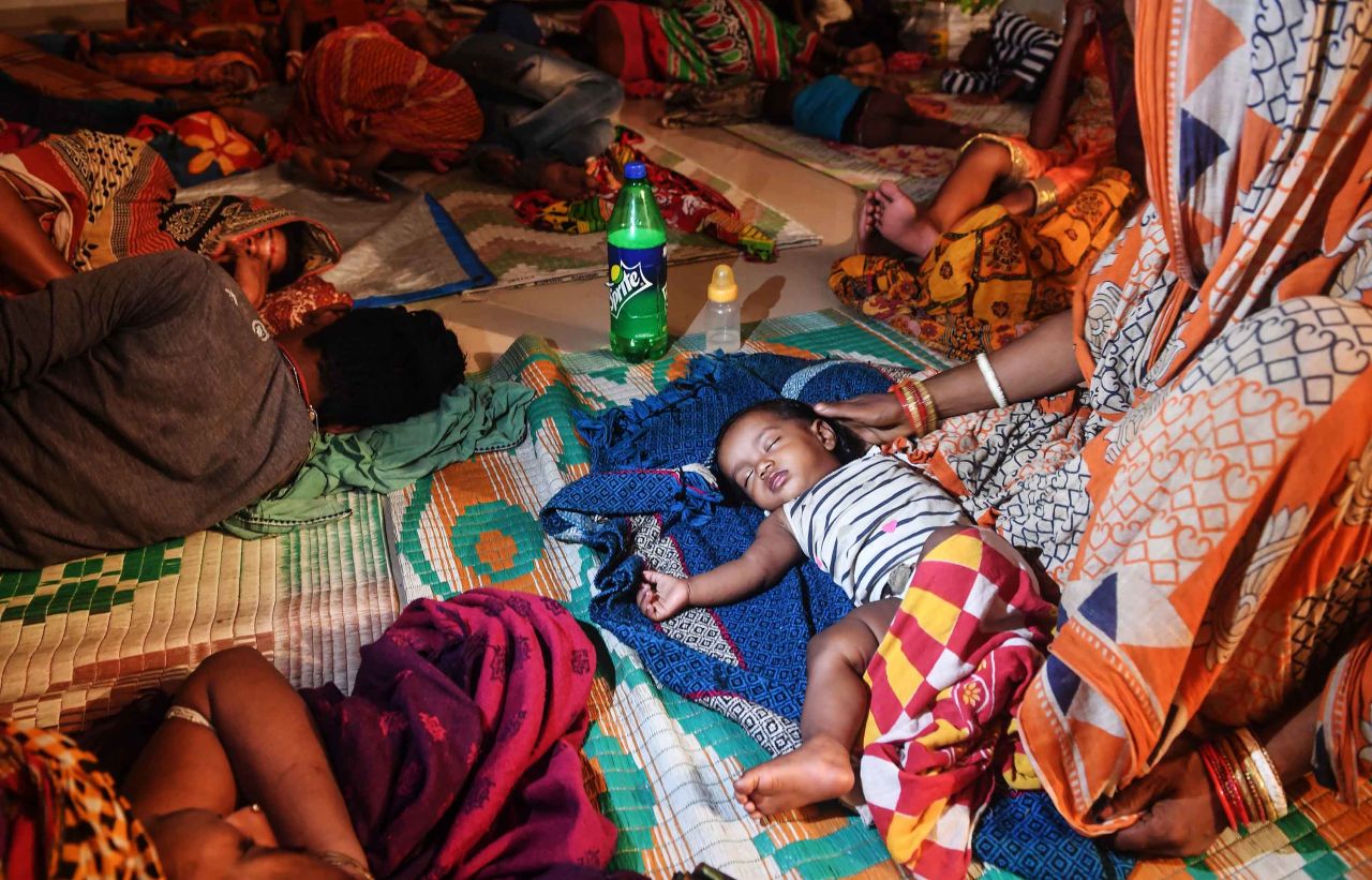 Evacuees rest in a temporary shelter in Puri.