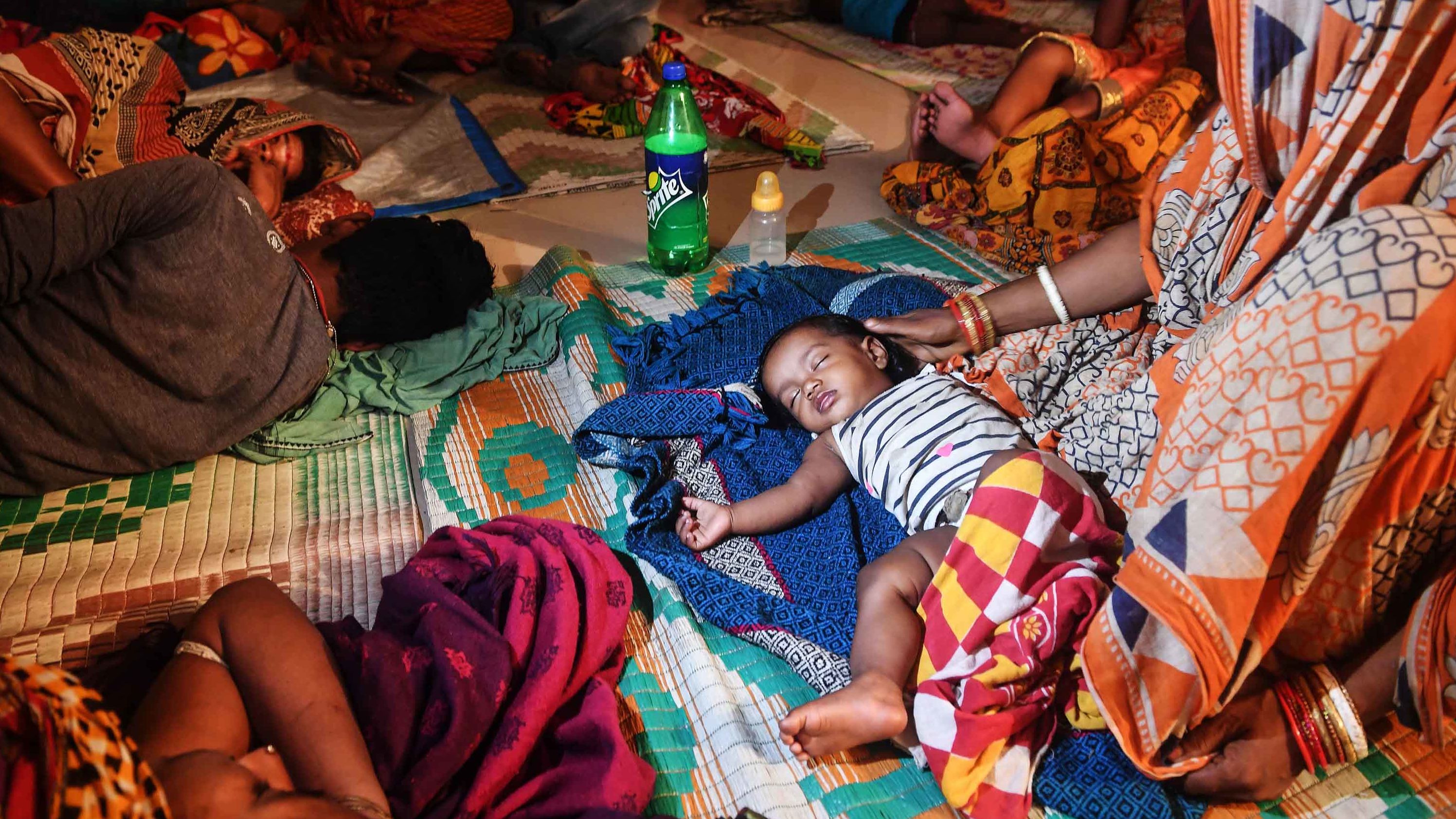 Evacuees rest in a temporary shelter in Puri.