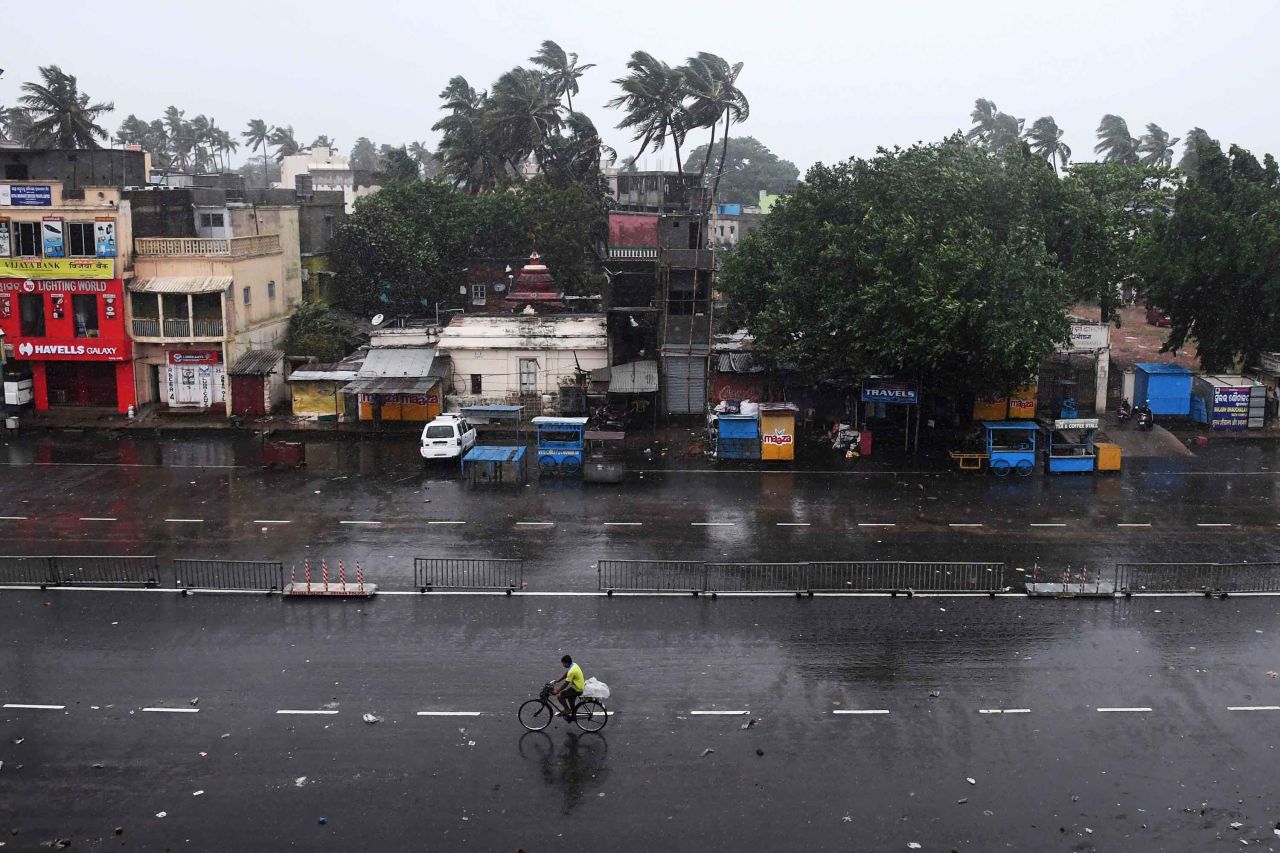 A commuter rides down a deserted road as the storm neared Puri on May 3.