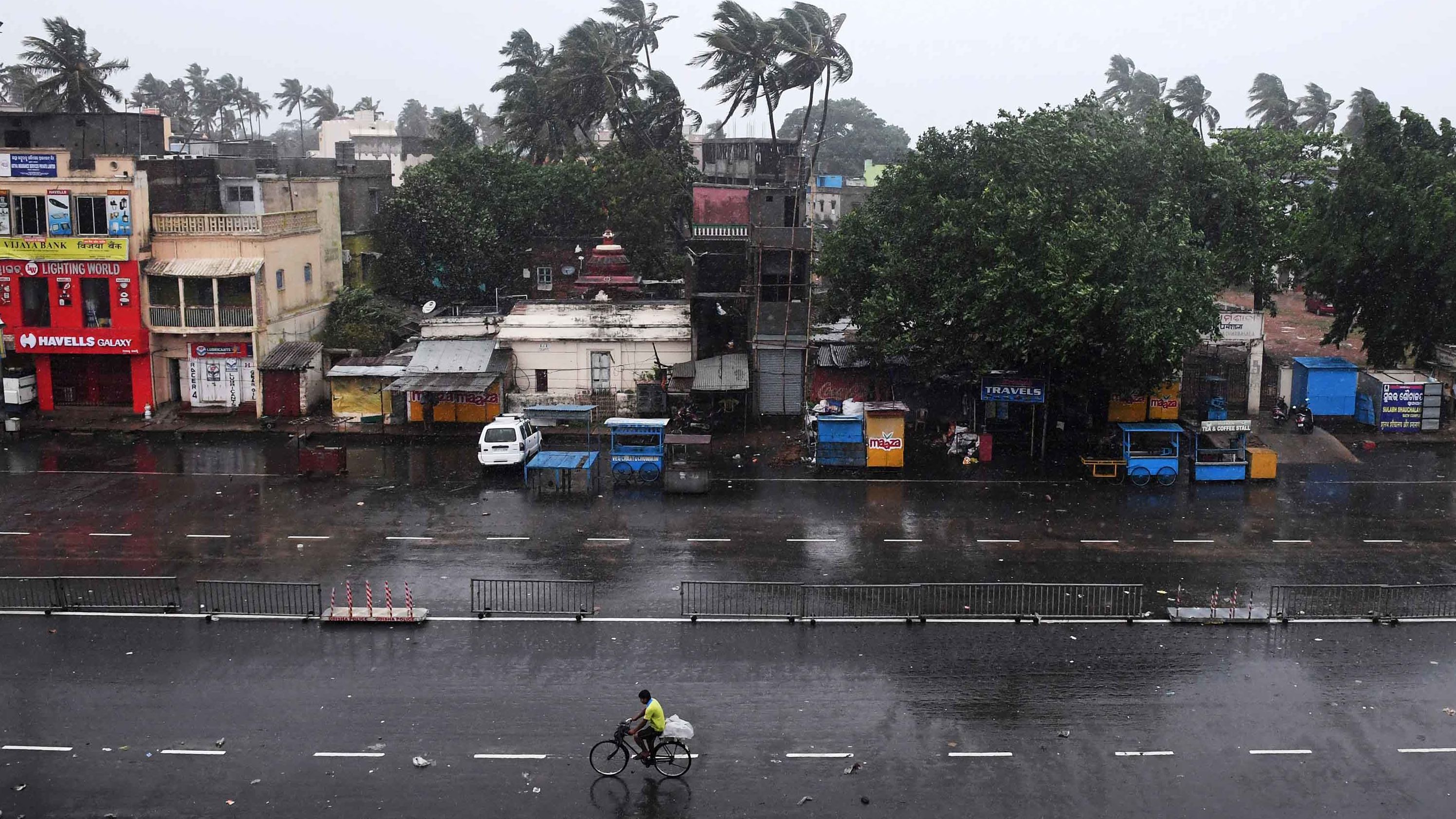 A commuter rides down a deserted road as the storm neared Puri on May 3.